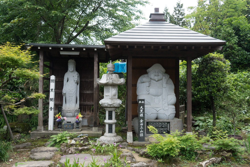 Buddhist Statues in the front garden of Daishinbo Shukubo Pilgrim Lodge on Mt. Haguro of the Dewa Sanzan